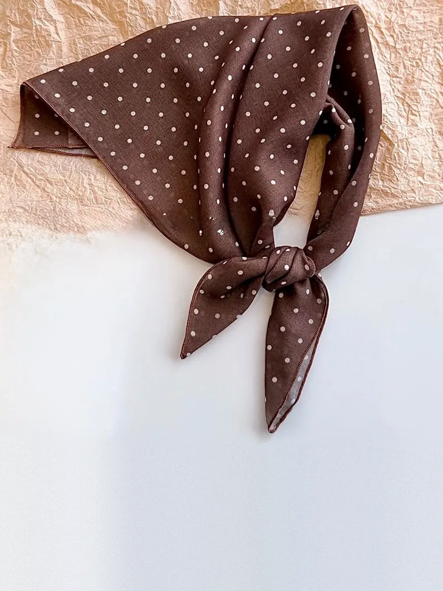 Kinkuu bandana in the brown polka dot print, tied and laid flat