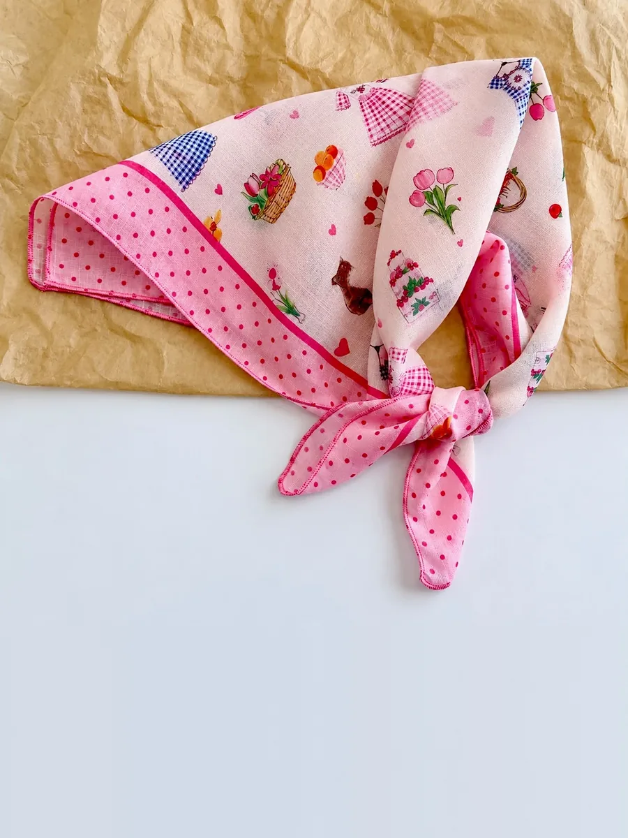 Kinkuu bandana in the pink picnic print, tied and laid flat