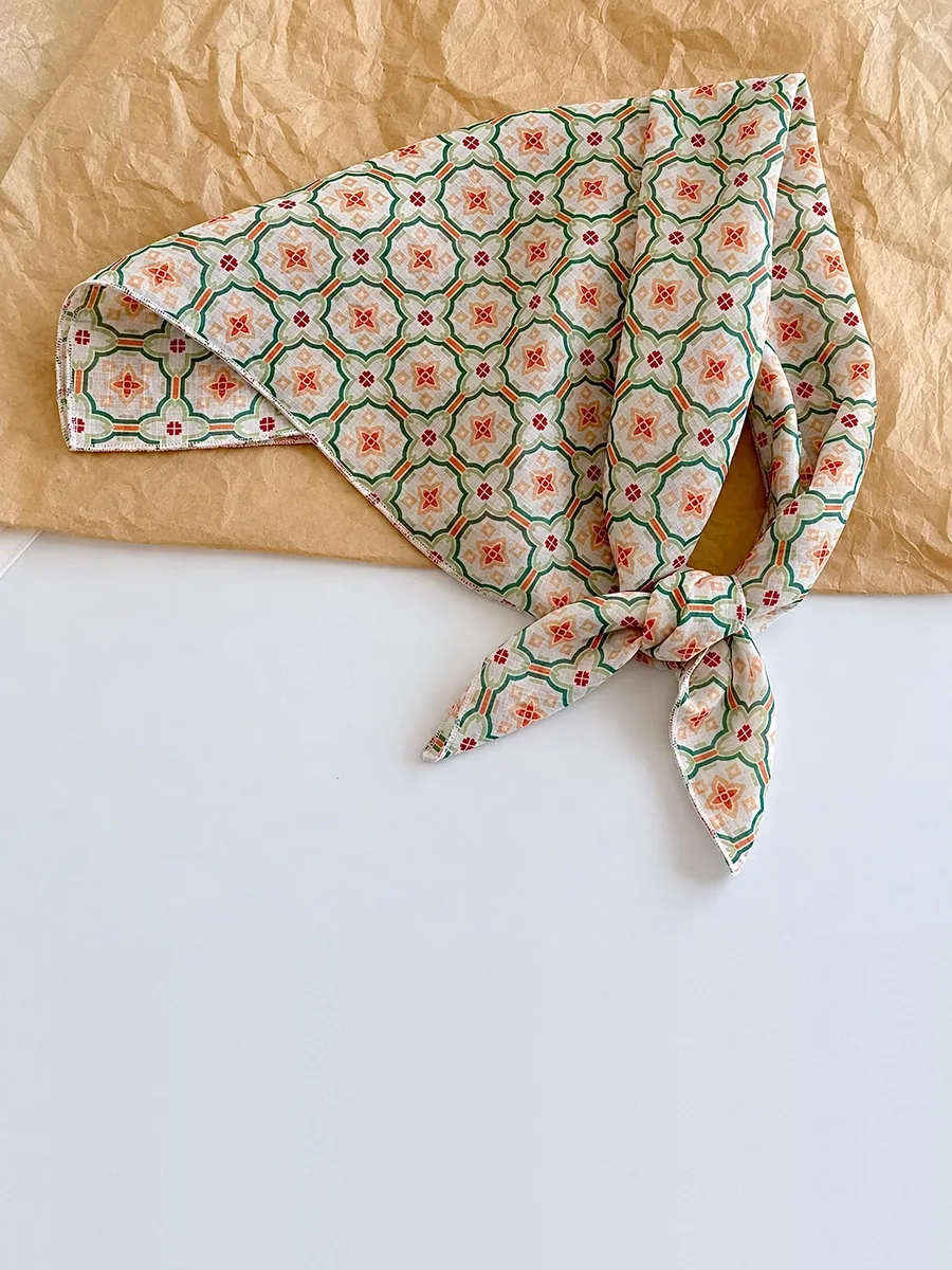 Kinkuu bandana in the garden tile print, tied and laid flat