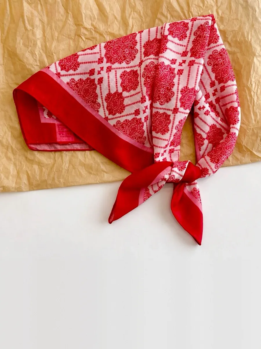 Kinkuu bandana in the red damask print, tied and laid flat