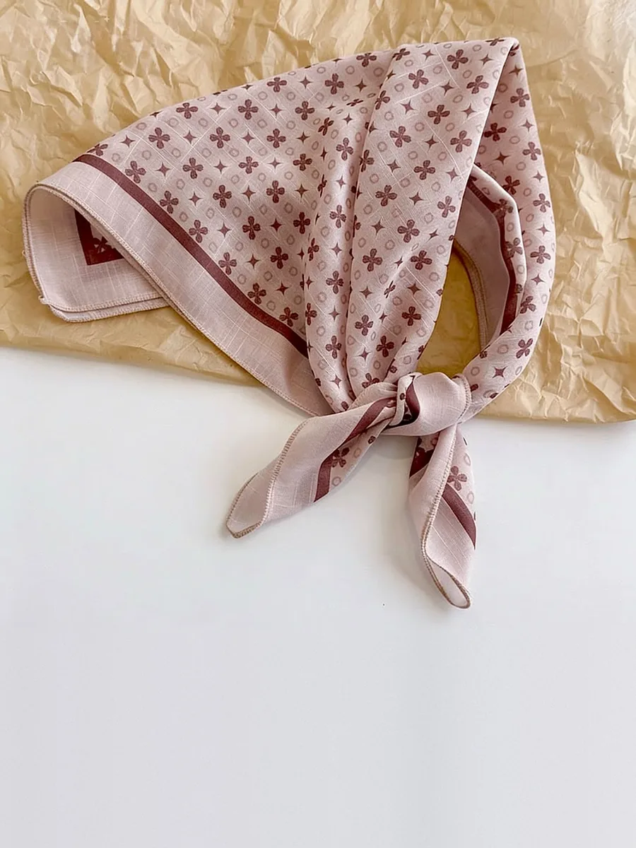 Kinkuu bandana in the blush clover print, tied and laid flat