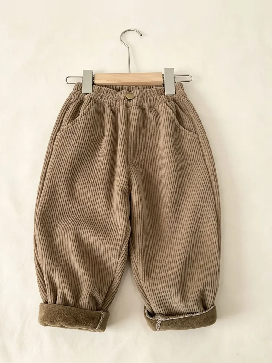 The fleece-lined cord trousers in camel, on a hanger