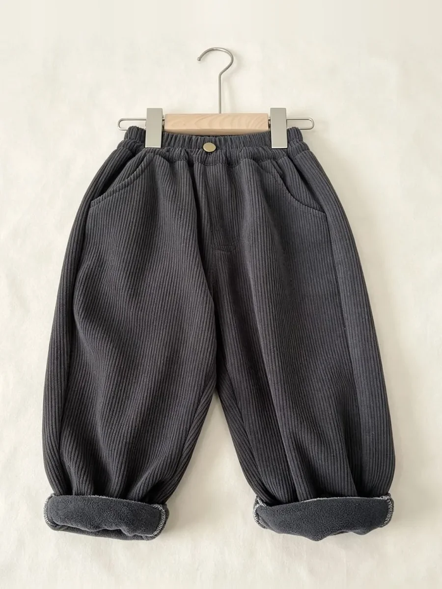 Kinkuu fleece-lined cord trousers in charcoal, cuffs rolled to show the fleece, on a hanger