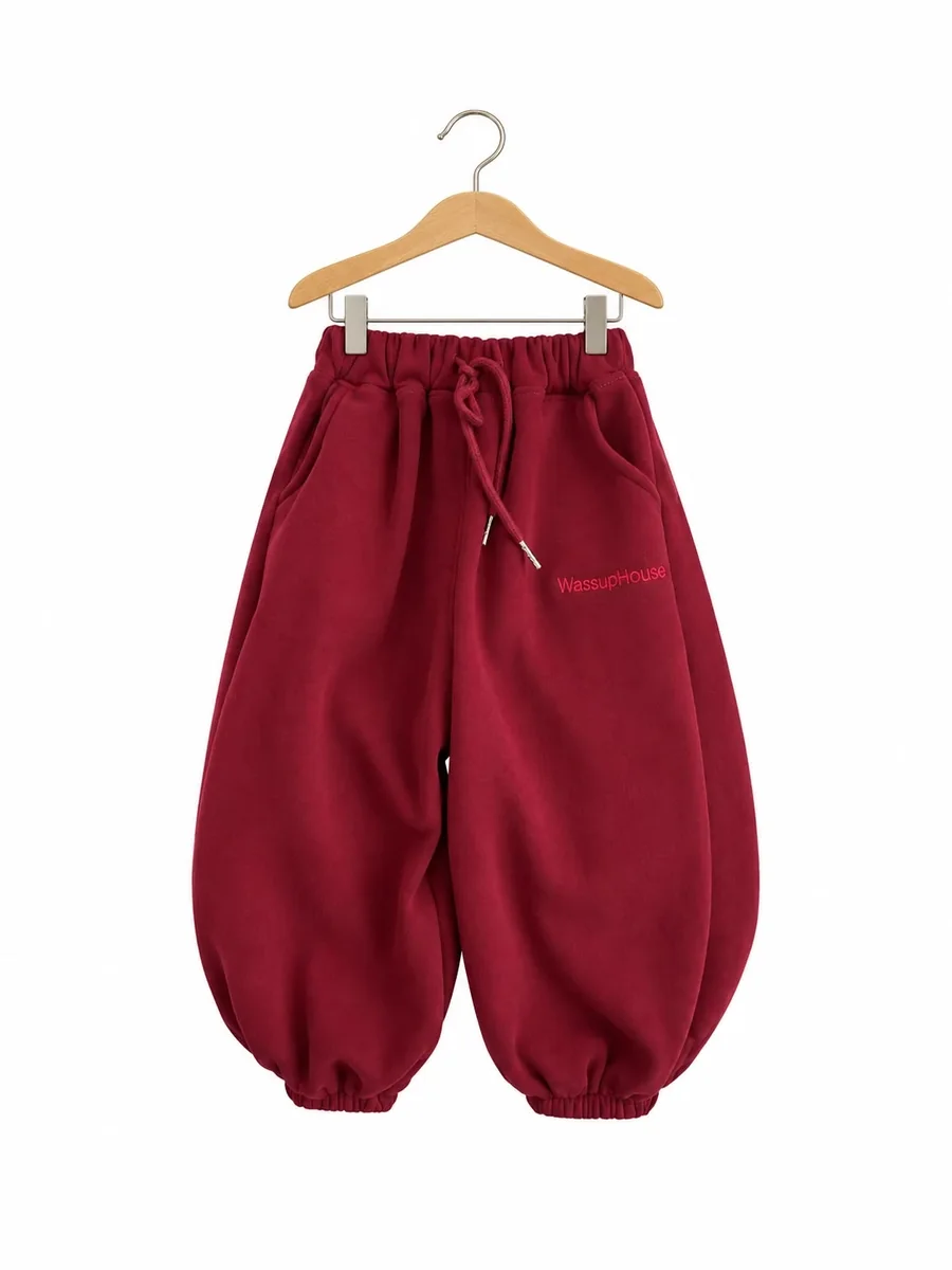 Kinkuu balloon joggers in burgundy, with a drawstring waist and elastic cuffs, on a hanger